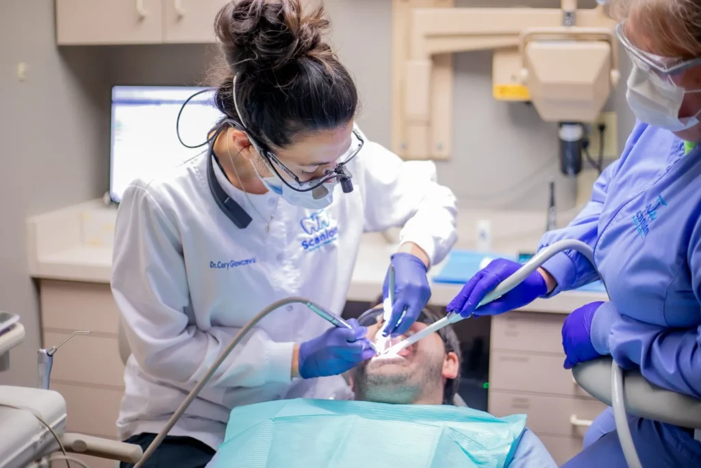 Dentist and dental assistant providing family dental care during an in-office procedure