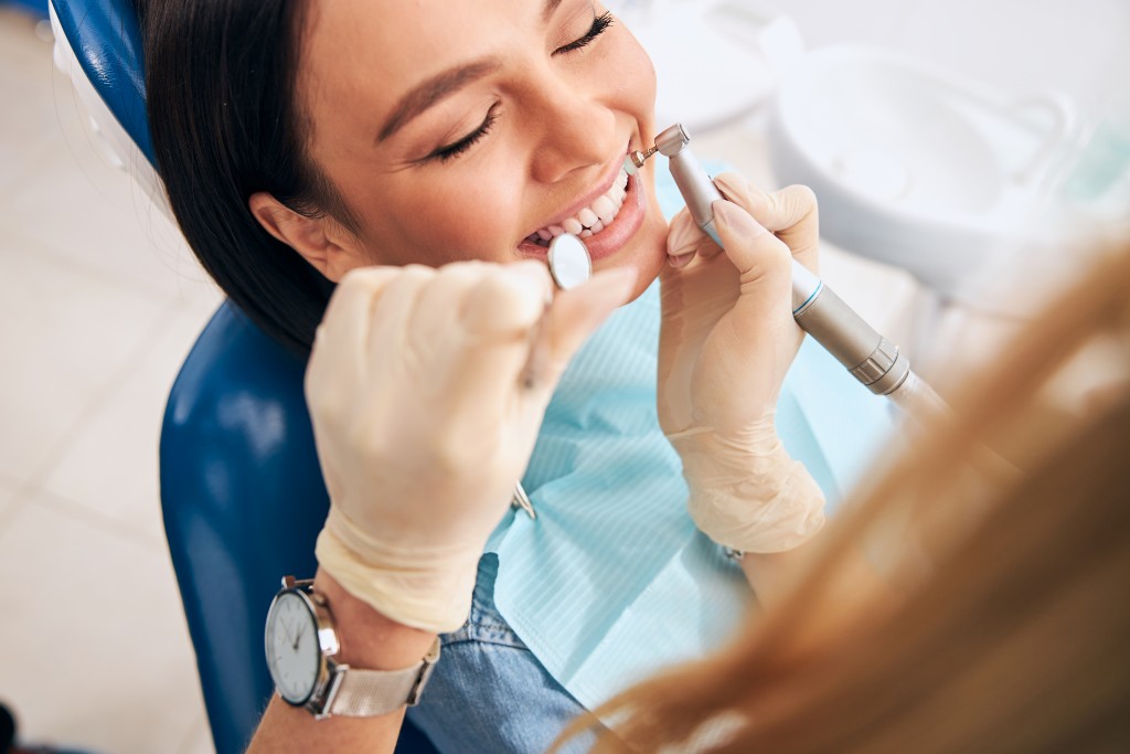 Dental hygienist performing a professional teeth cleaning during a routine dental visit